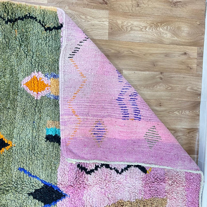 Vintage Moroccan Berber rug with abstract tribal design on pink wool, handmade in Morocco