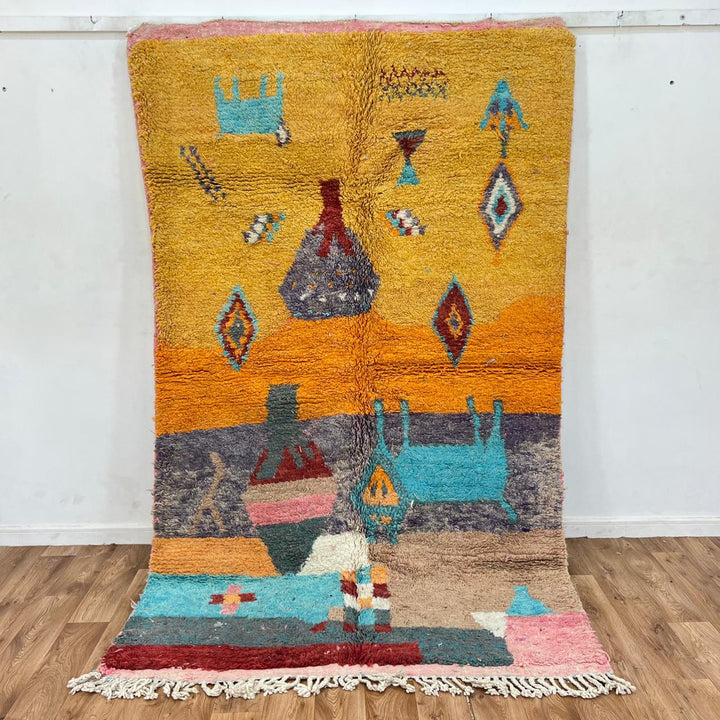 Vintage Moroccan golden wool rug with turquoise and tribal Berber symbols, handmade in Morocco
