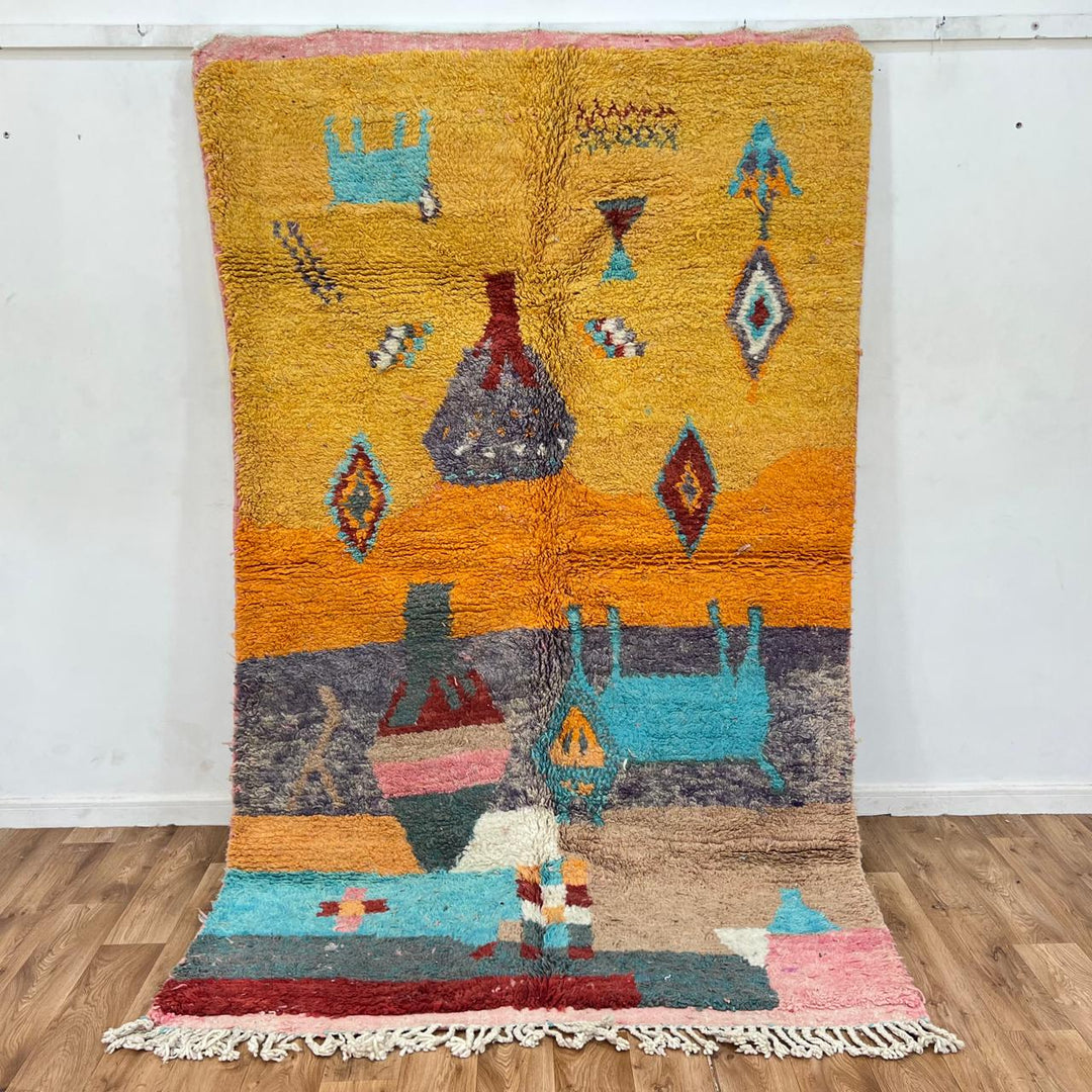 Vintage Moroccan golden wool rug with turquoise and tribal Berber symbols, handmade in Morocco