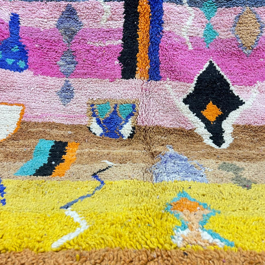 Vintage Moroccan Berber rug with abstract tribal design on pink wool, handmade in Morocco