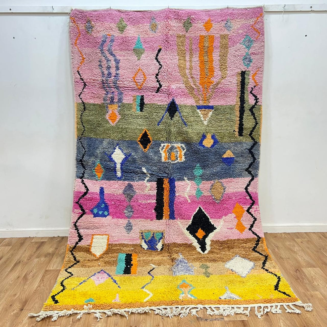 Vintage Moroccan Berber rug with abstract tribal design on pink wool, handmade in Morocco