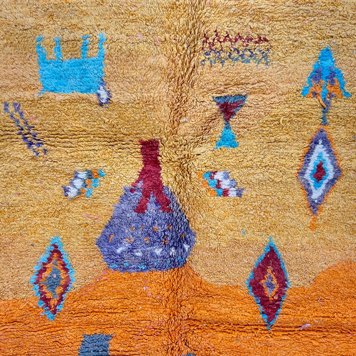 Vintage Moroccan golden wool rug with turquoise and tribal Berber symbols, handmade in Morocco