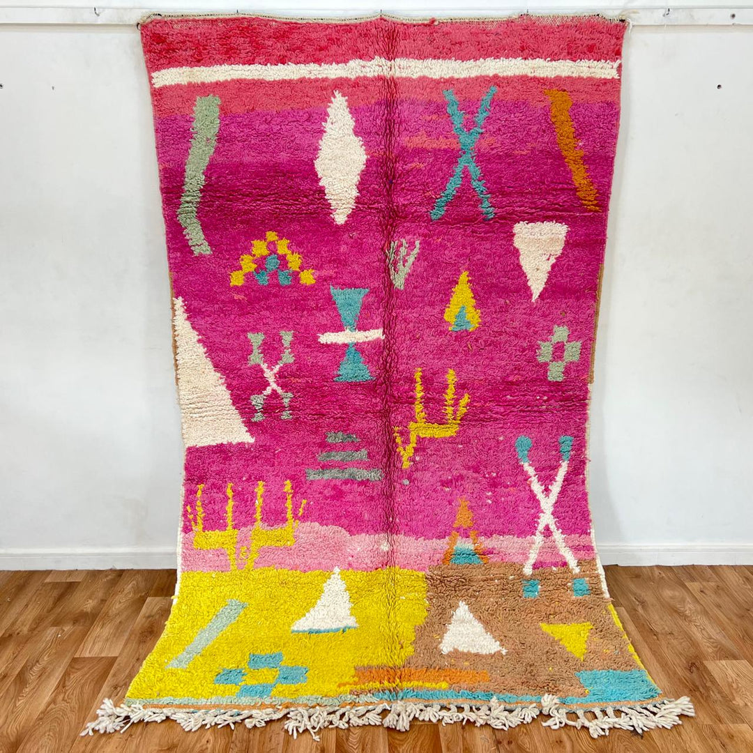 Vintage Moroccan wool rug in pink and yellow tones with abstract Berber geometric patterns, handmade in Morocco