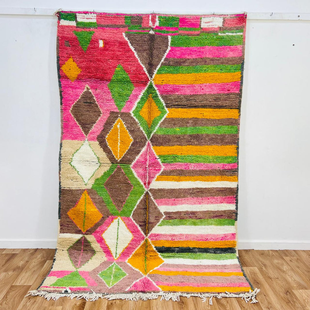 Vintage Moroccan wool rug with colorful Berber diamond and stripe patterns in pink, green and mustard