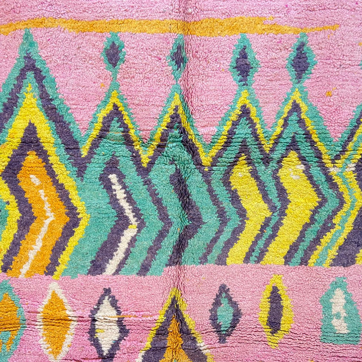 Vintage Moroccan wool rug with colorful Berber geometric pattern on pink background, 260x161 cm