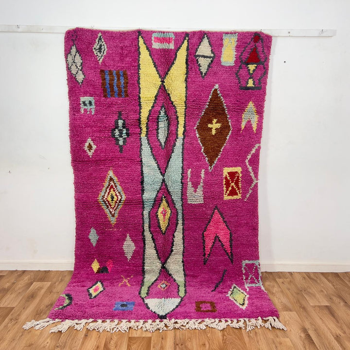 vintage moroccan wool rug with pink background and berber tribal symbols handmade shag rug