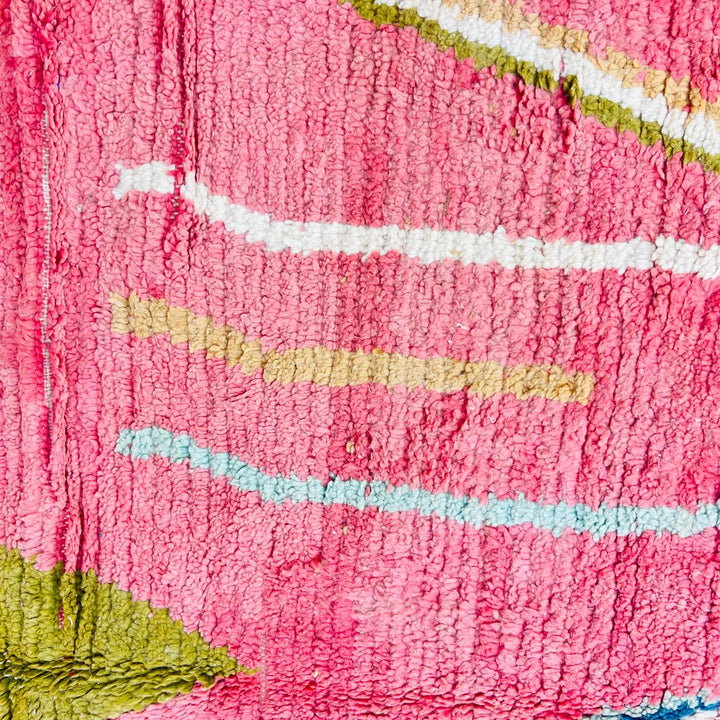 Vintage Moroccan wool rug with pink background and colorful Berber geometric symbols, handmade in Morocco