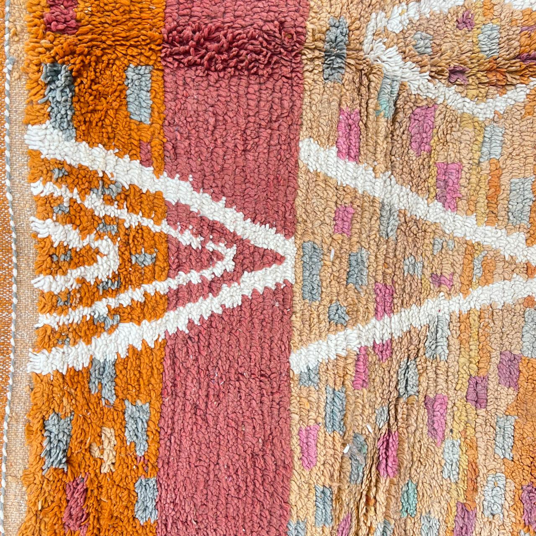 Vintage Moroccan wool rug in orange tones with white Berber diamond patterns, handmade in Morocco