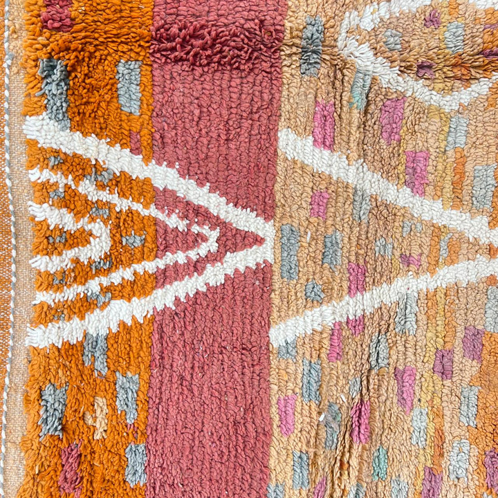 Vintage Moroccan wool rug in orange tones with white Berber diamond patterns, handmade in Morocco