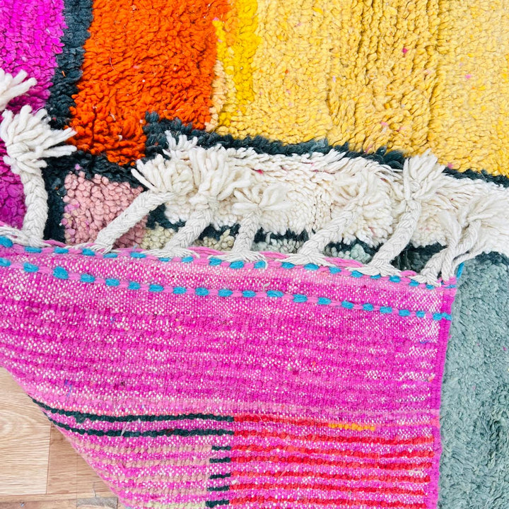 Vintage Moroccan wool rug with colorful geometric Berber pattern in pink yellow green and cream – handmade in Morocco