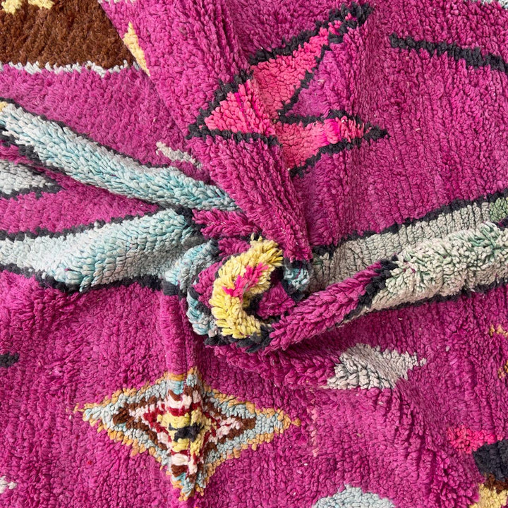 vintage moroccan wool rug with pink background and berber tribal symbols handmade shag rug