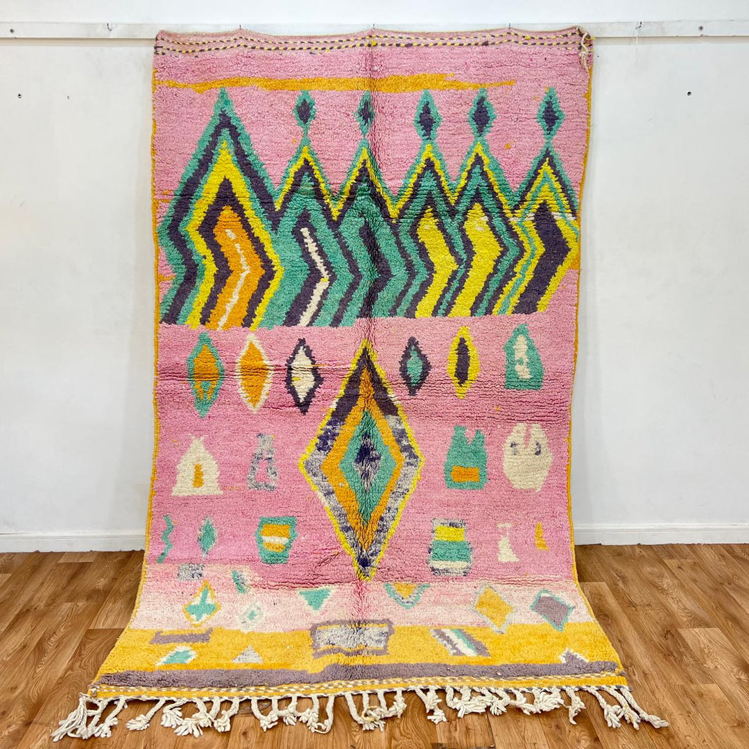Vintage Moroccan wool rug with colorful Berber geometric pattern on pink background, 260x161 cm