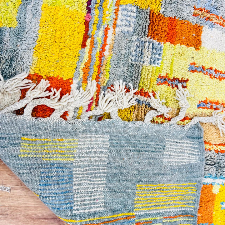 Vintage Moroccan wool rug with geometric patterns in yellow, grey, teal and orange – handmade Berber rug from Morocco