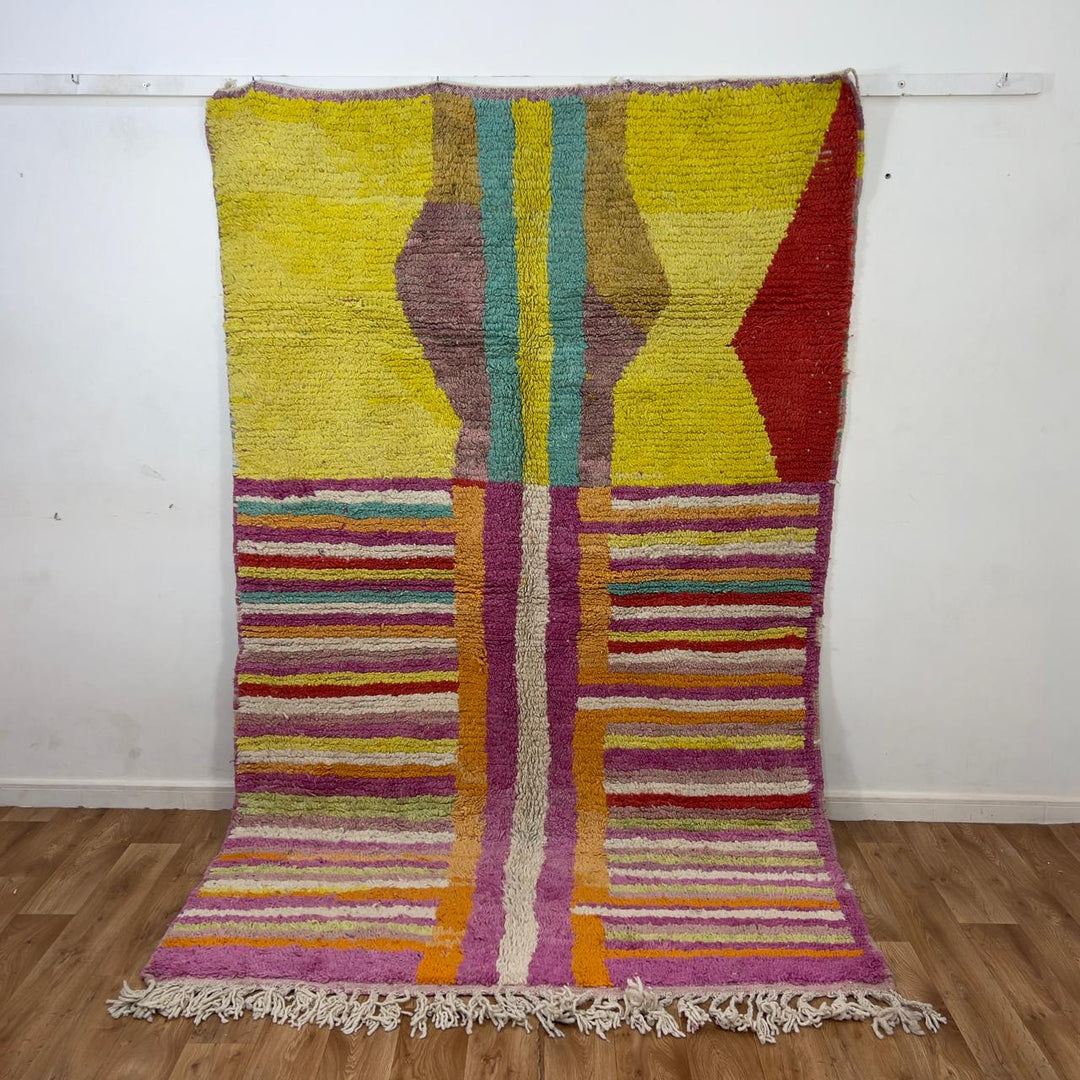 Vintage Moroccan wool rug 8.53x5.84 ft, handmade Berber shag rug with colorful striped pattern and central geometric design in yellow, pink, turquoise and red tones