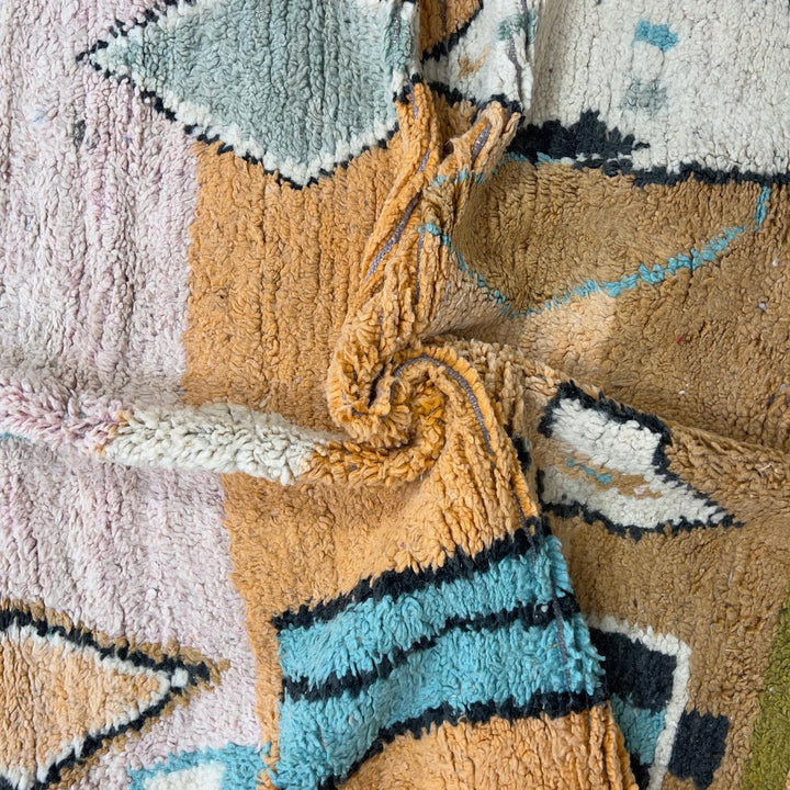 Vintage Moroccan wool rug with abstract geometric patterns in beige, mustard, and turquoise tones, handmade Berber carpet