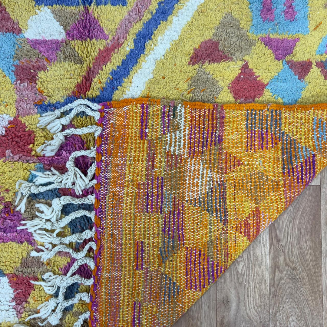 Vintage Moroccan wool rug 8.53x5.25 ft, handmade Berber rug with colorful triangle pattern and bold diagonal stripe design on yellow background