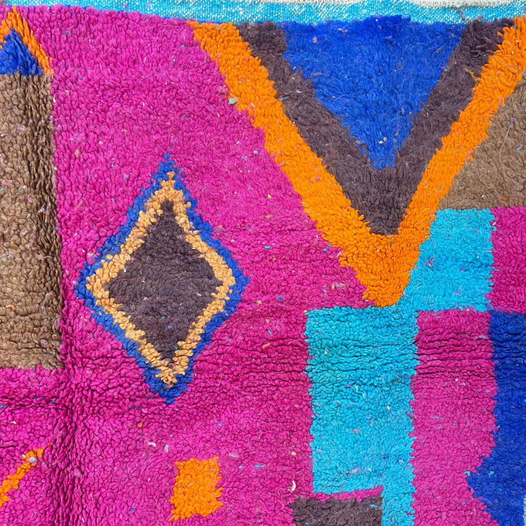 Vintage Moroccan wool rug with colorful Berber geometric patterns in pink, blue, and orange