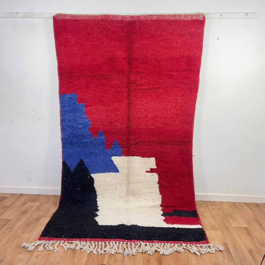Vintage Moroccan wool rug in deep red with abstract black, ivory, and blue color blocks, handmade Berber rug