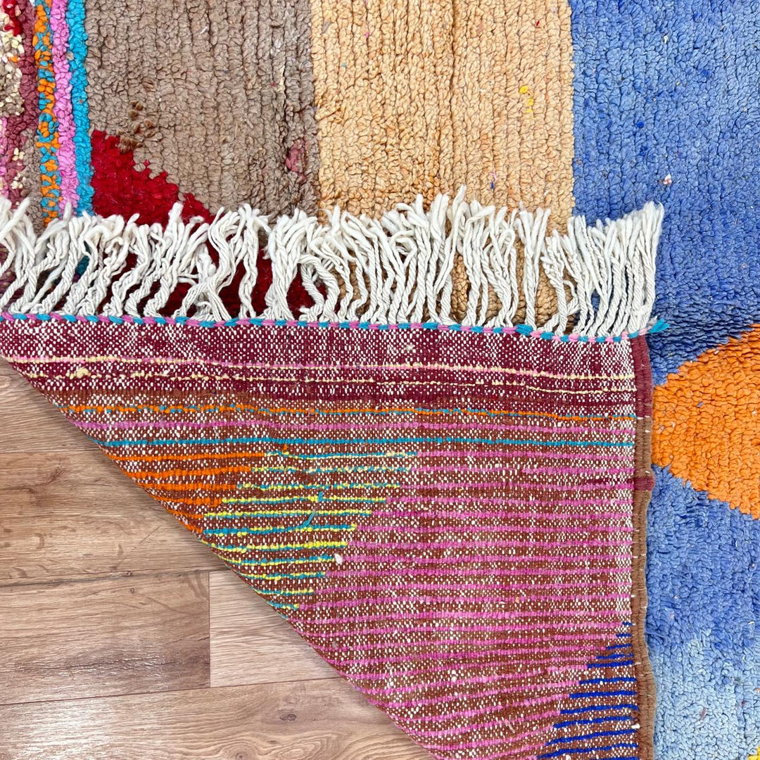 Vintage Moroccan wool rug with bold geometric Berber patterns in turquoise, red, and mustard