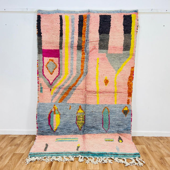 Vintage Moroccan wool rug with blush pink base and abstract Berber line patterns