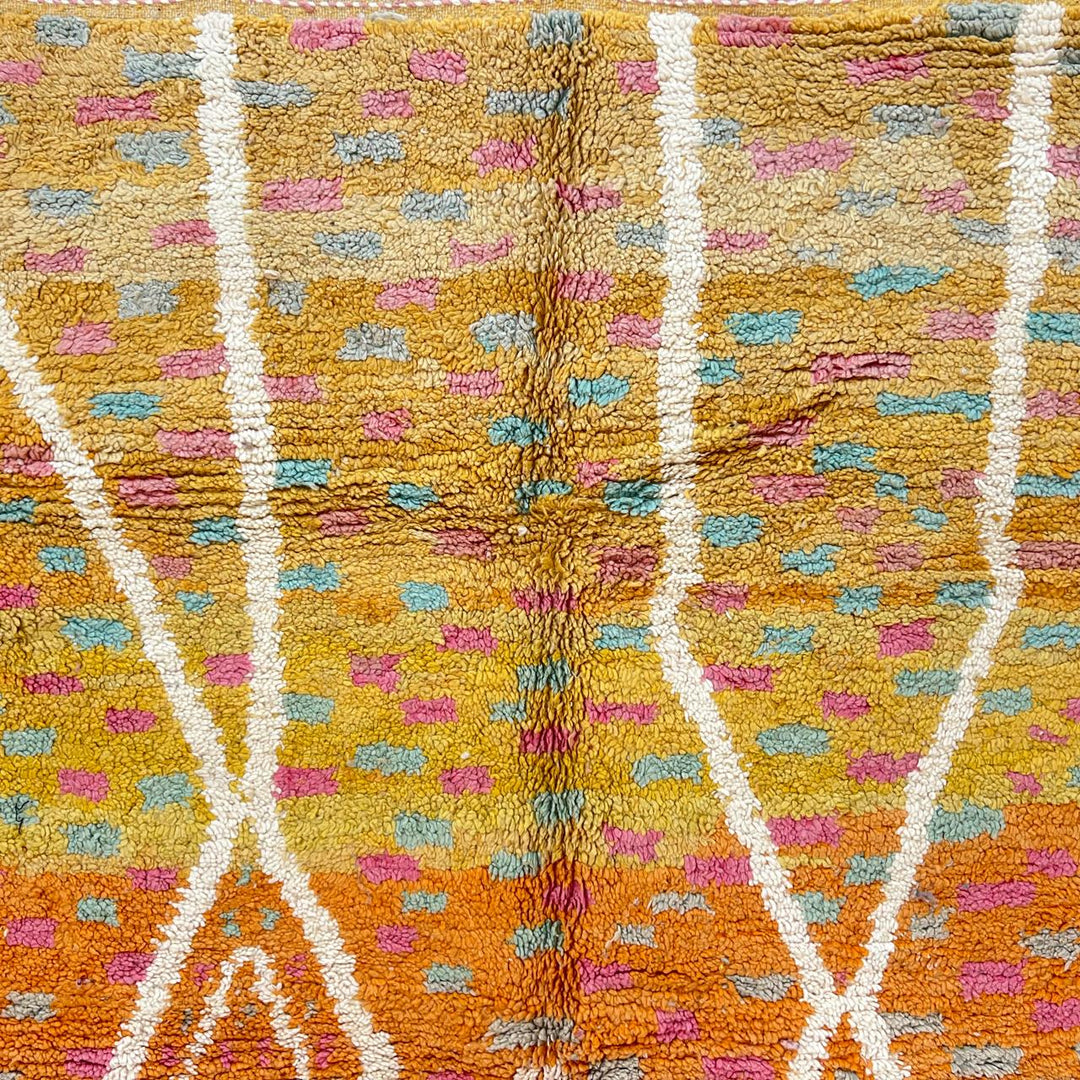 Vintage Moroccan wool rug in orange tones with white Berber diamond patterns, handmade in Morocco
