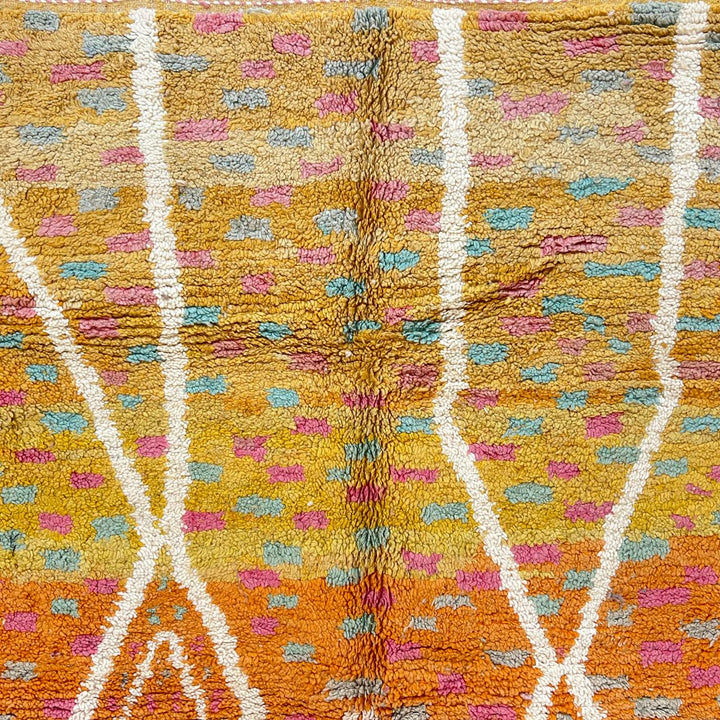 Vintage Moroccan wool rug in orange tones with white Berber diamond patterns, handmade in Morocco