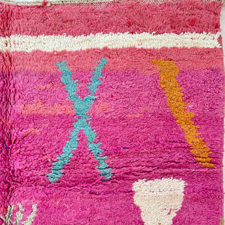 Vintage Moroccan wool rug in pink and yellow tones with abstract Berber geometric patterns, handmade in Morocco