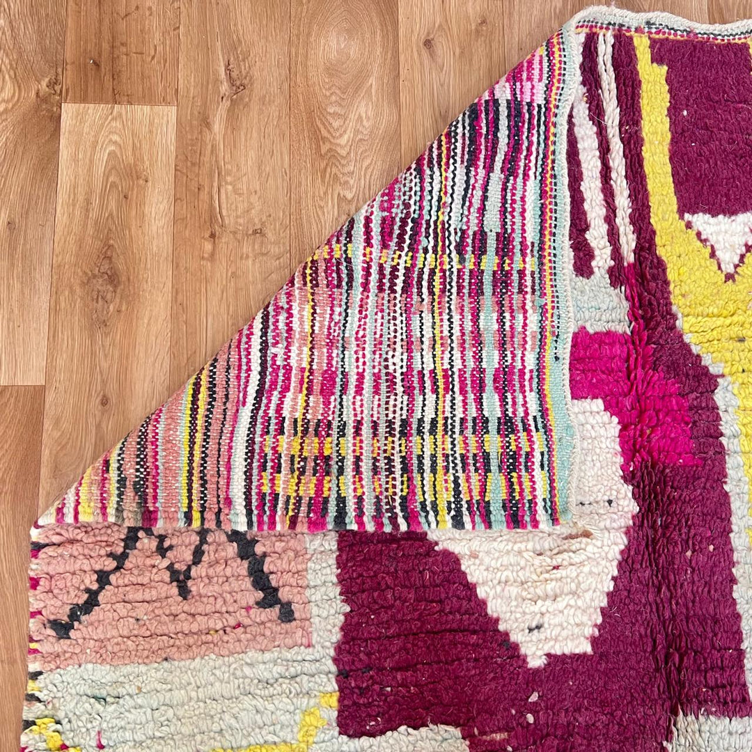 Vintage Moroccan wool rug with colorful abstract Berber geometric design in burgundy, pink, yellow and grey tones