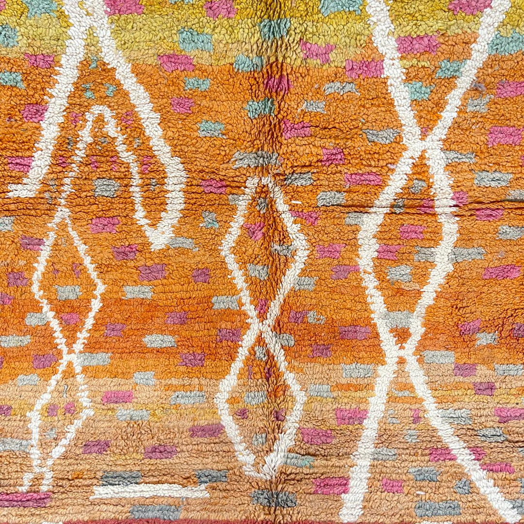 Vintage Moroccan wool rug in orange tones with white Berber diamond patterns, handmade in Morocco