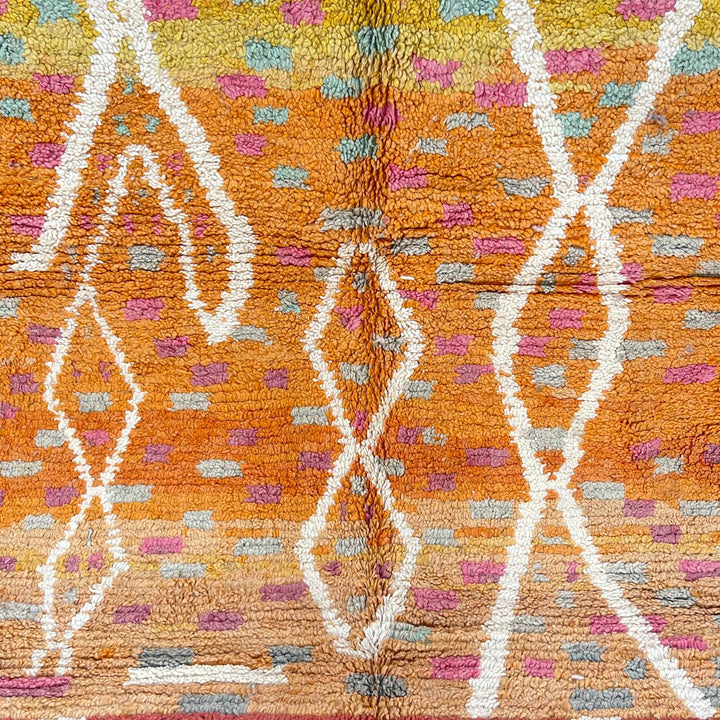 Vintage Moroccan wool rug in orange tones with white Berber diamond patterns, handmade in Morocco