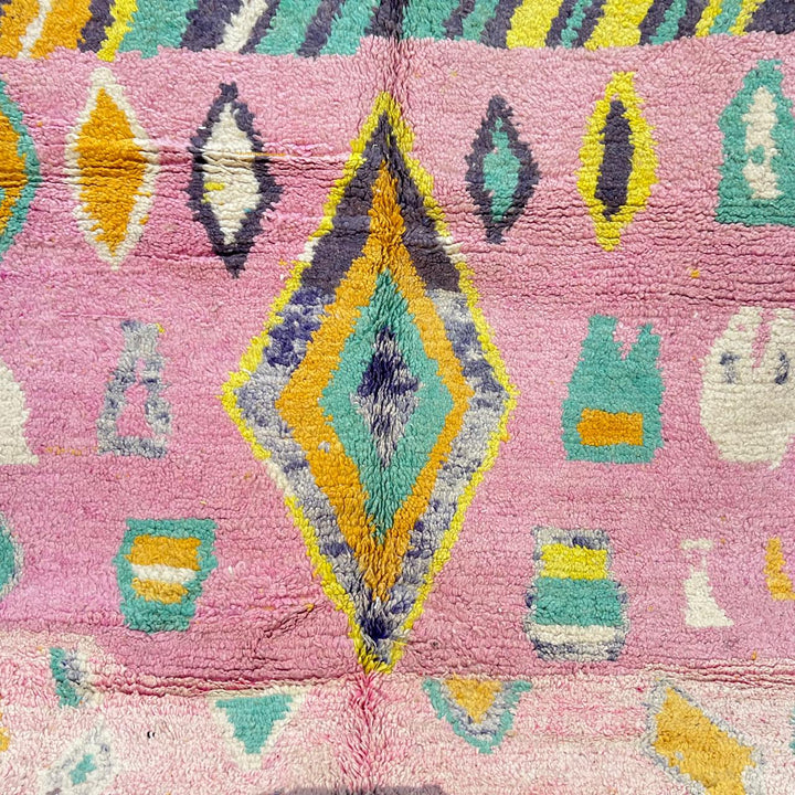 Vintage Moroccan wool rug with colorful Berber geometric pattern on pink background, 260x161 cm