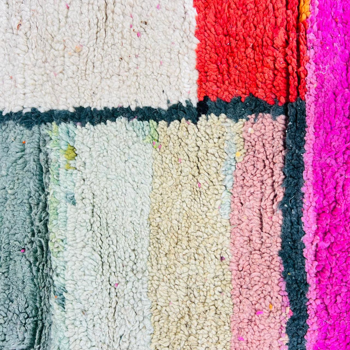Vintage Moroccan wool rug with colorful geometric Berber pattern in pink yellow green and cream – handmade in Morocco