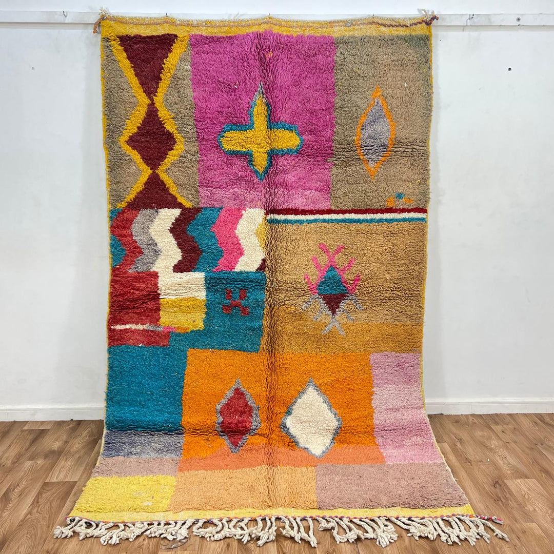 Vintage Moroccan wool rug with colorful patchwork blocks and tribal symbols in yellow, orange, pink and turquoise, handwoven Berber carpet 254x159 cm