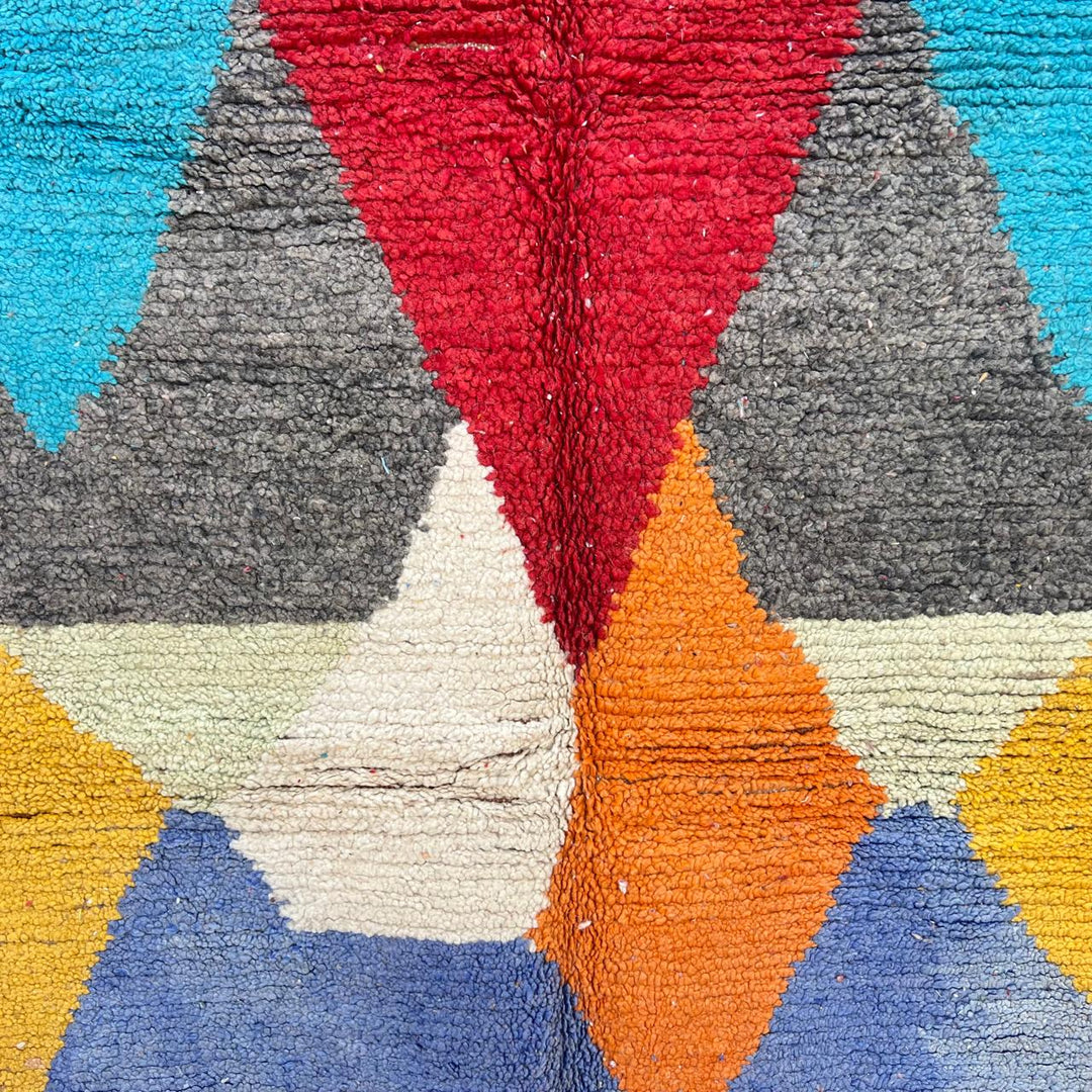 Vintage Moroccan wool rug with bold geometric Berber patterns in turquoise, red, and mustard