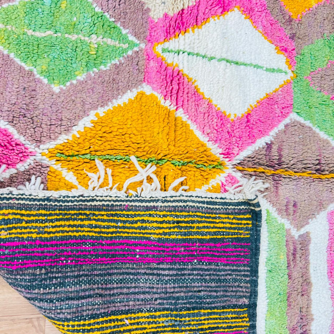 Vintage Moroccan wool rug with colorful Berber diamond and stripe patterns in pink, green and mustard