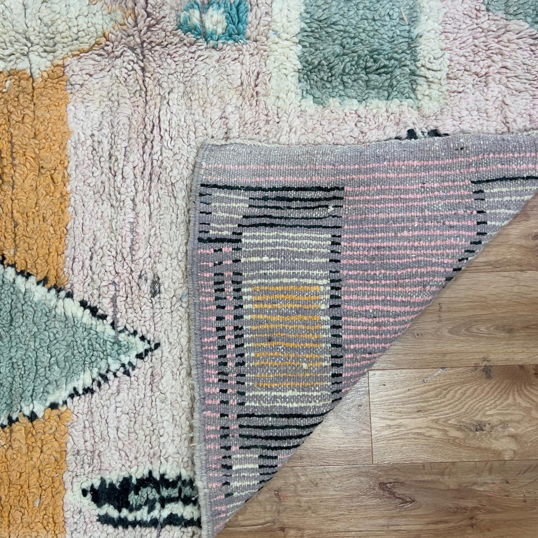 Vintage Moroccan wool rug with abstract geometric patterns in beige, mustard, and turquoise tones, handmade Berber carpet
