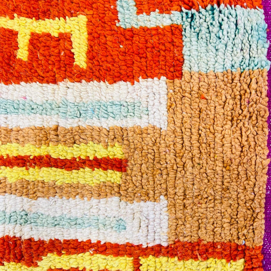 Vintage Moroccan wool rug with colorful Berber geometric symbols, handmade in Morocco