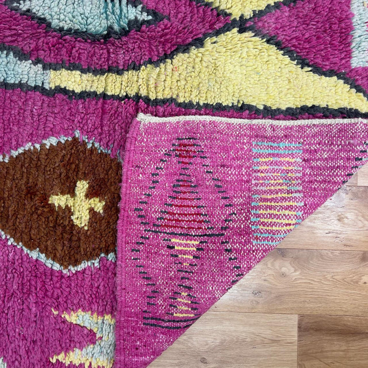 vintage moroccan wool rug with pink background and berber tribal symbols handmade shag rug