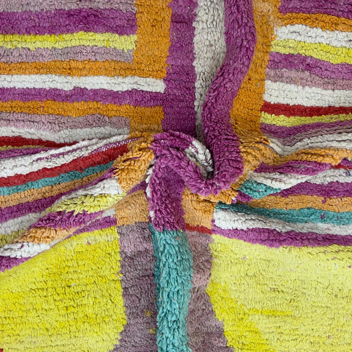 Vintage Moroccan wool rug 8.53x5.84 ft, handmade Berber shag rug with colorful striped pattern and central geometric design in yellow, pink, turquoise and red tones