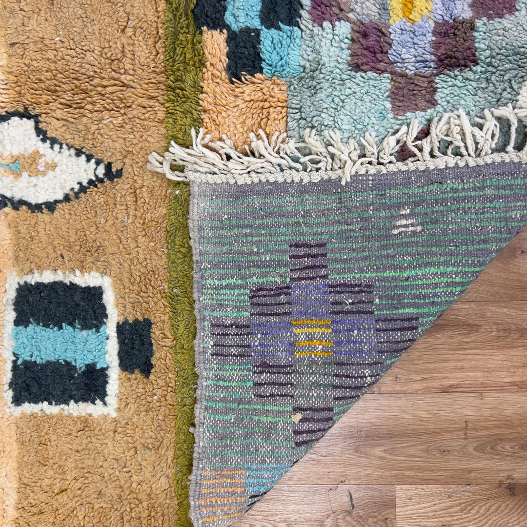 Vintage Moroccan wool rug with abstract geometric patterns in beige, mustard, and turquoise tones, handmade Berber carpet