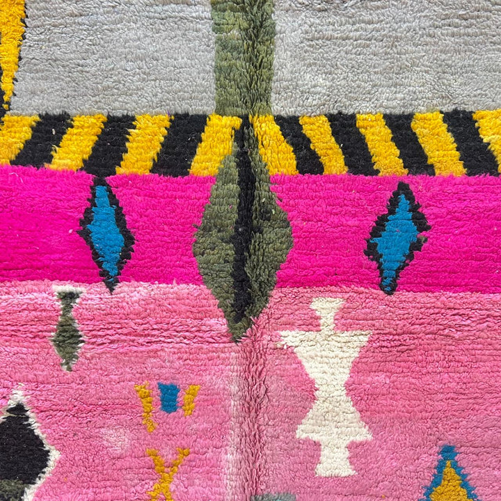 Vintage Moroccan wool rug with pink background and colorful Berber symbols, handmade in Morocco
