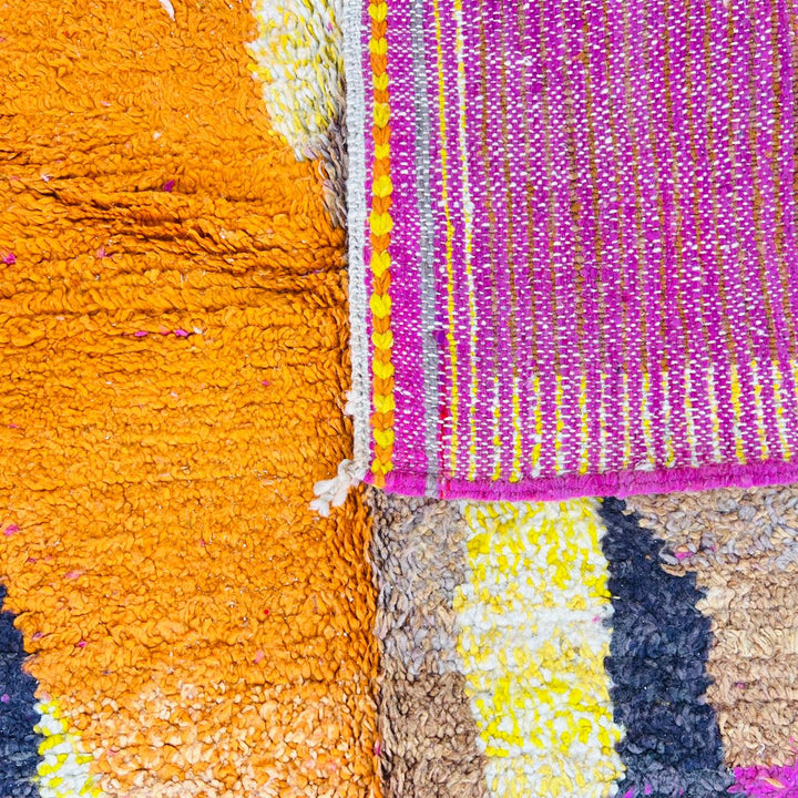 Handmade vintage Moroccan wool rug in pink and yellow with abstract Berber design. One-of-a-kind artisan rug, 255×166 cm.