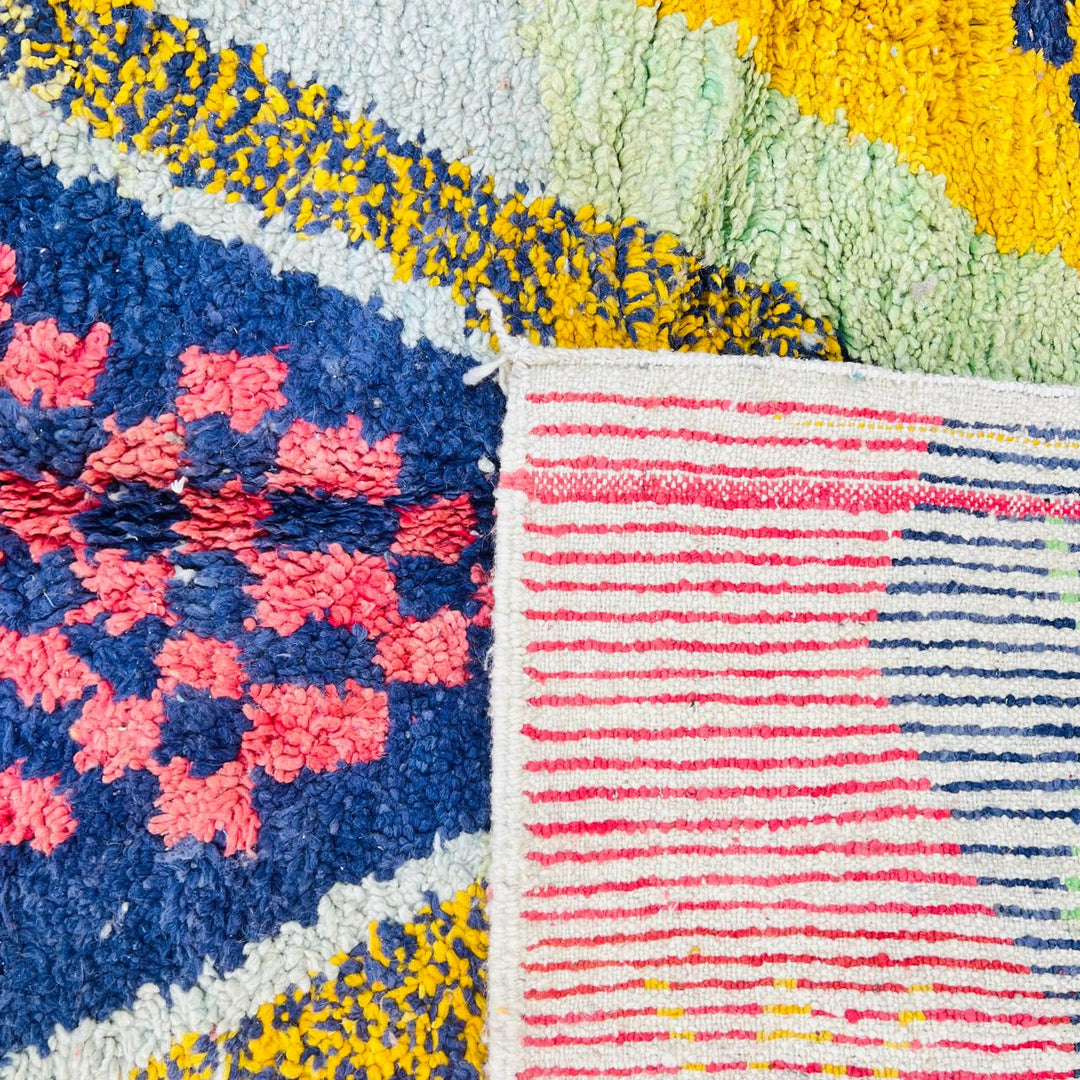 Vintage Moroccan wool rug with abstract Berber geometric design in coral pink, mustard yellow, navy and cream, handmade in Morocco