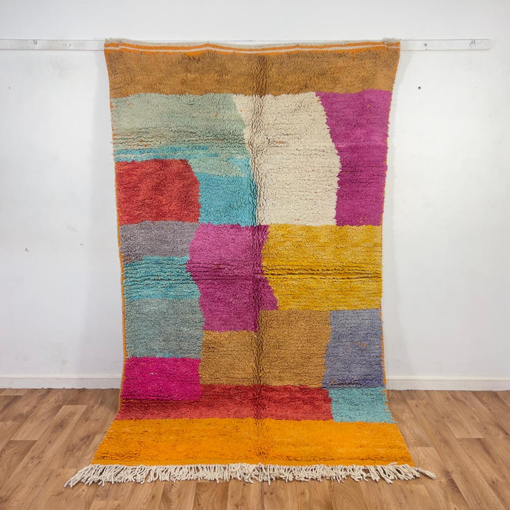 Vintage Moroccan wool rug with colorful patchwork blocks in orange, pink, yellow and blue tones, handmade Berber rug 8.33 x 5.09 ft