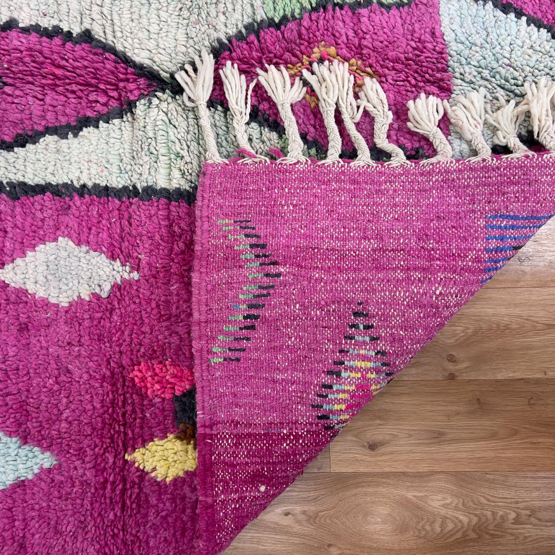 vintage moroccan wool rug with pink background and berber tribal symbols handmade shag rug