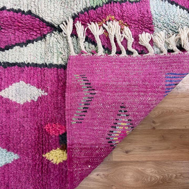 vintage moroccan wool rug with pink background and berber tribal symbols handmade shag rug