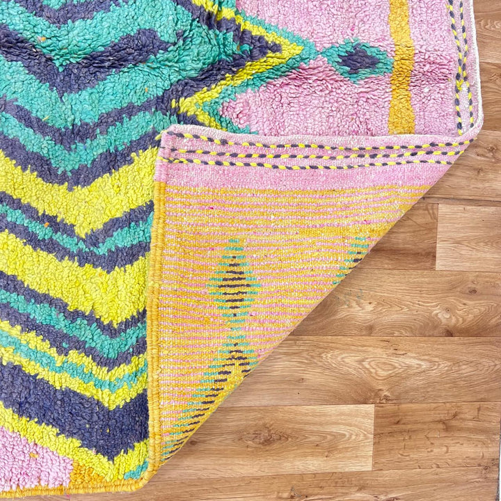 Vintage Moroccan wool rug with colorful Berber geometric pattern on pink background, 260x161 cm