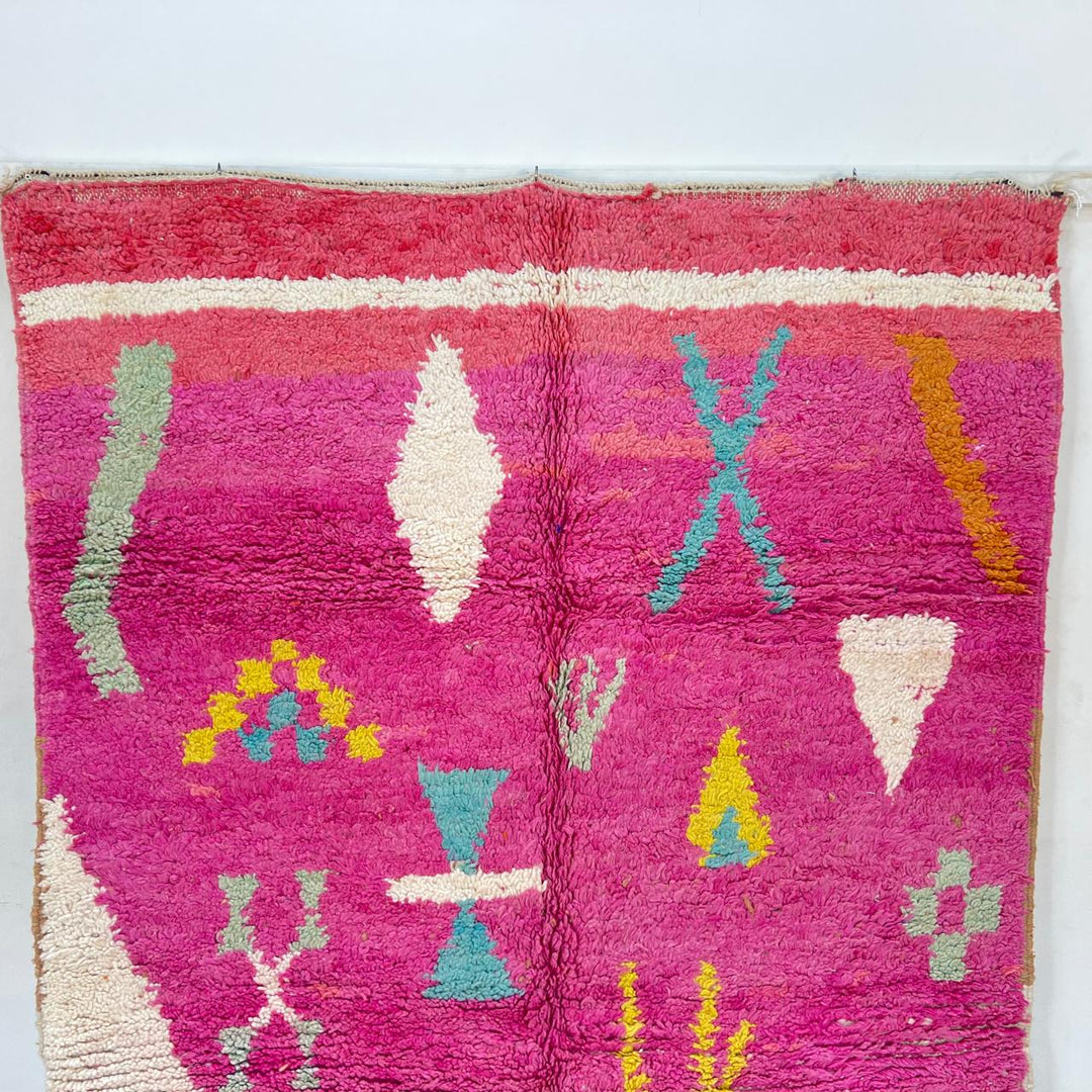 Vintage Moroccan wool rug in pink and yellow tones with abstract Berber geometric patterns, handmade in Morocco
