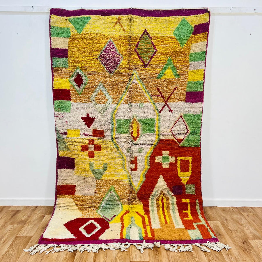 Vintage Moroccan wool rug with colorful Berber geometric symbols, handmade in Morocco
