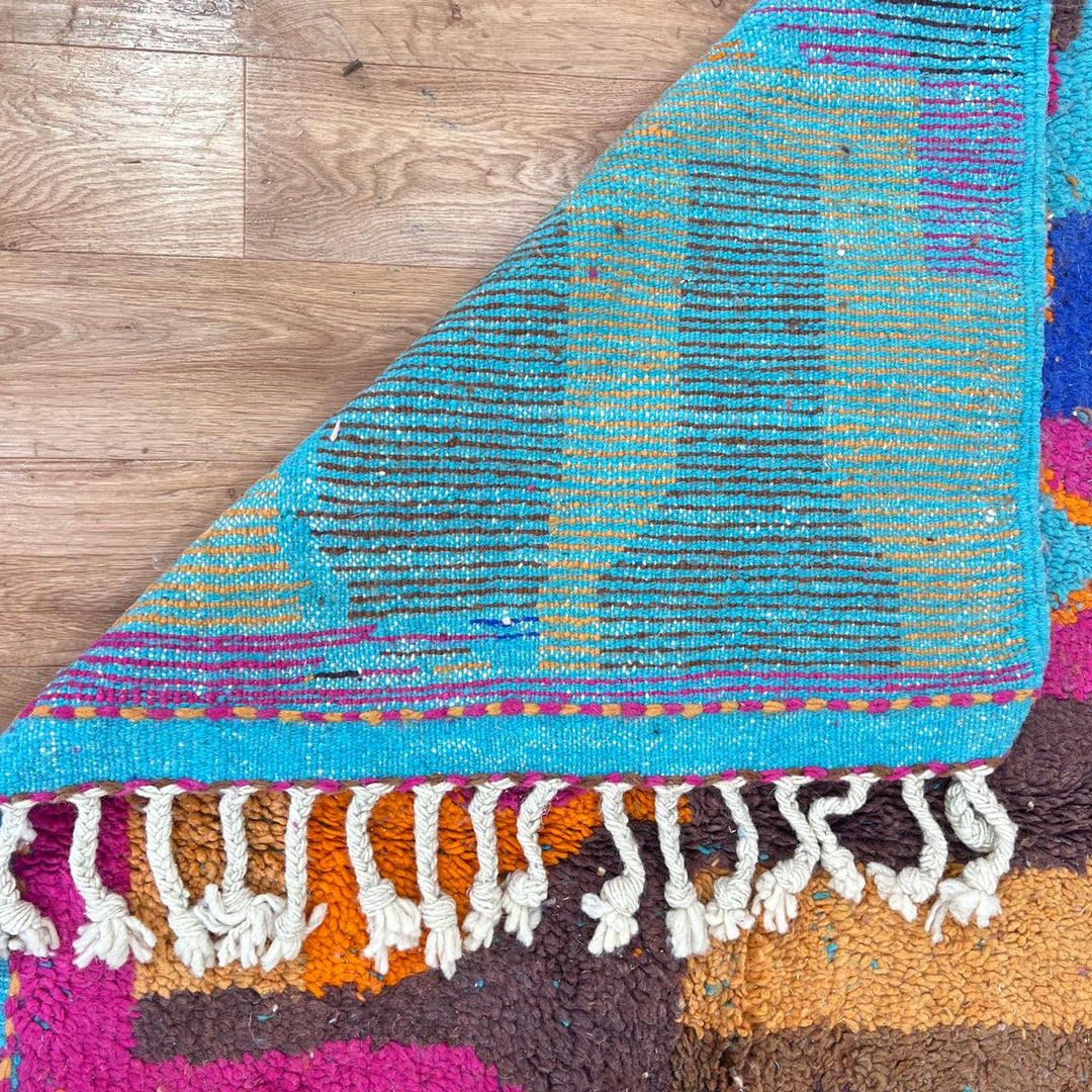Vintage Moroccan wool rug with colorful Berber geometric patterns in pink, blue, and orange